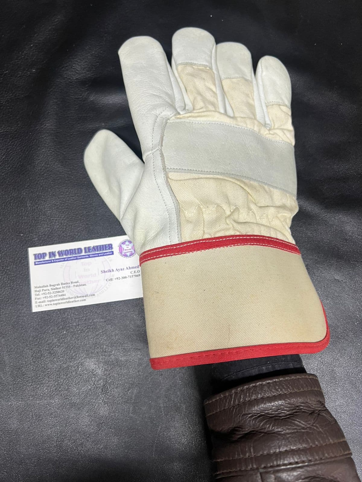 White leather work glove with red trimmed cuff